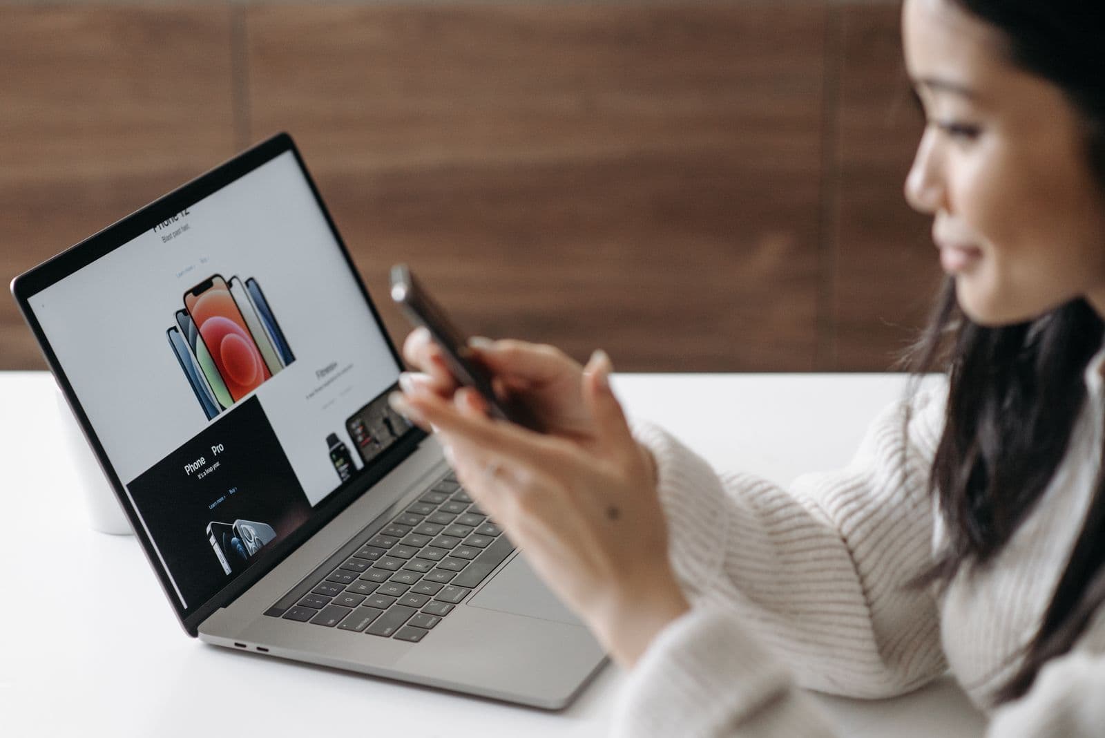 An entrepreneur managing an online store from a laptop and phone